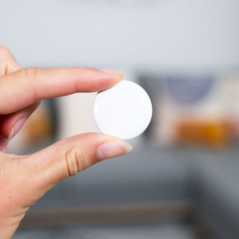 Person holding access control RFID coin tag