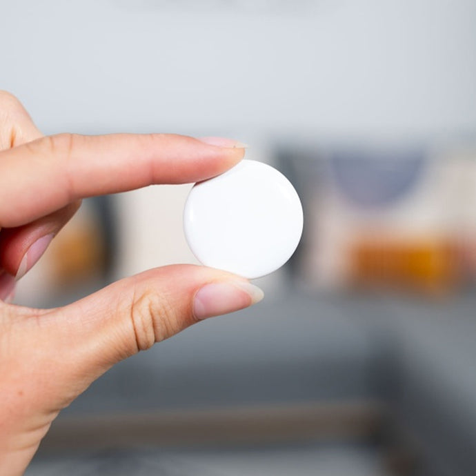 Person holding access control RFID coin tag