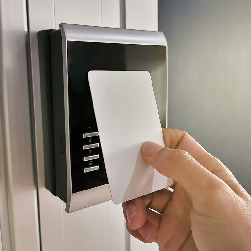 Person using access control key card credential on interior building card reader