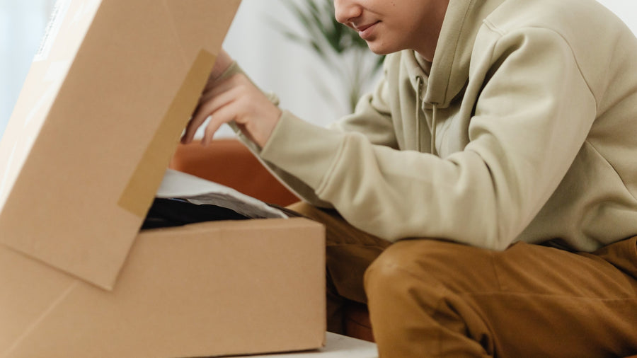 Man opening brown cardboard bundle box