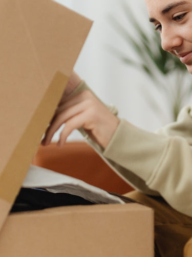 Man opening brown cardboard bundle box