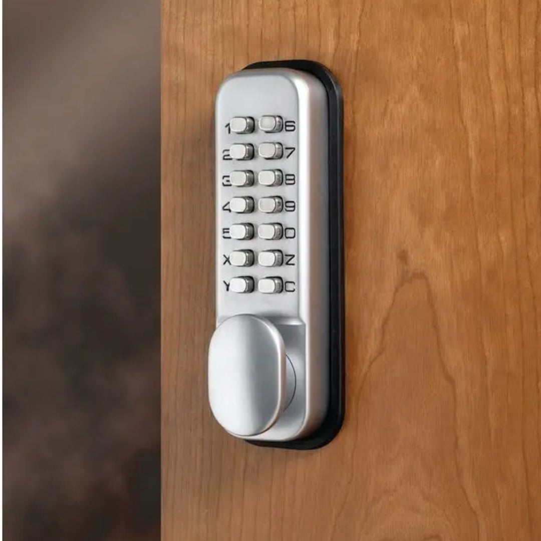silver combination lock with numeric keypad installed on brown wooden door