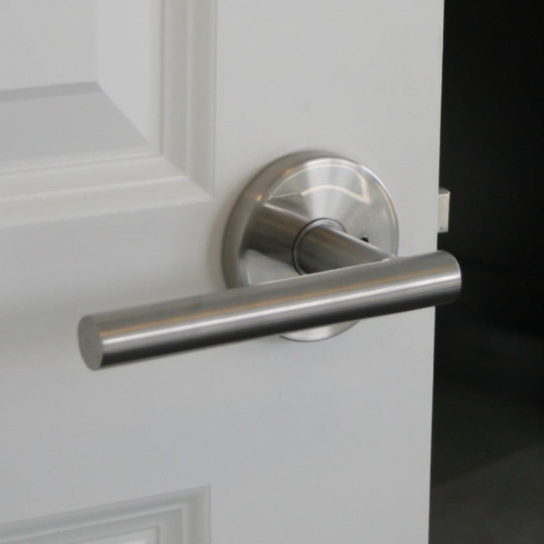 silver passage lock on white wooden interior door
